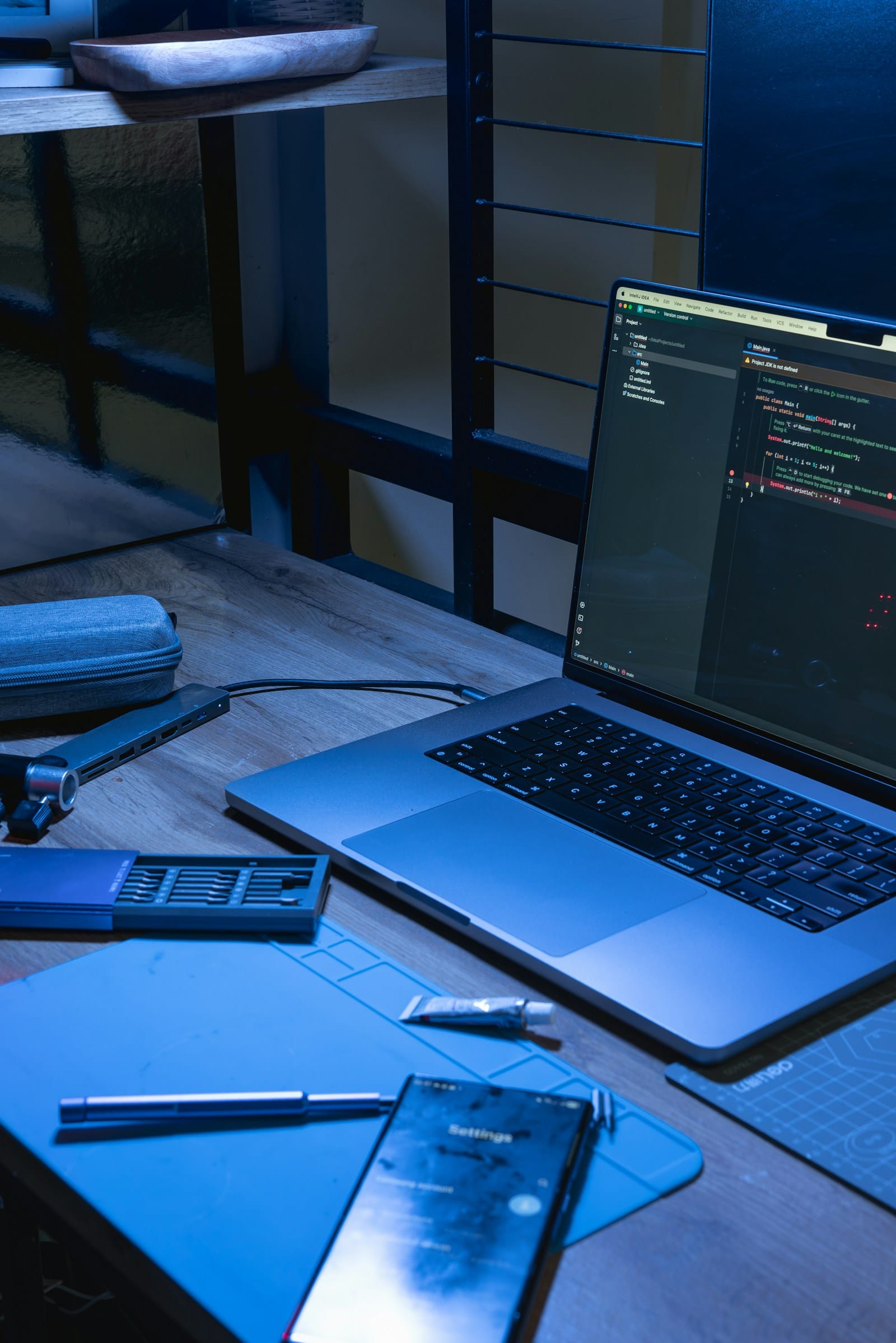 AI App Builders for Non-Developers laptop and smartphone with coding software open