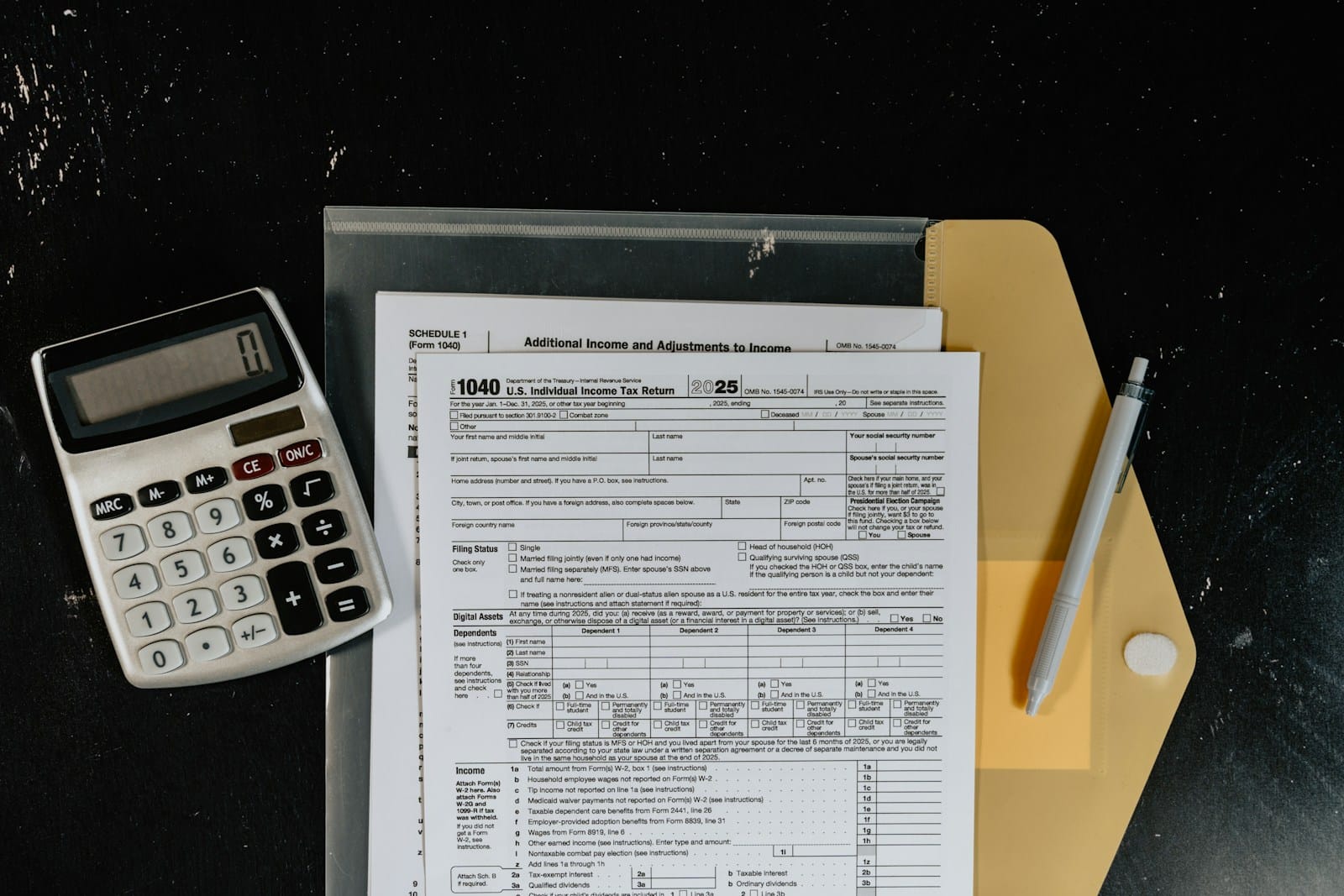 AI Finance Tools (for Freelancers) to Automate Taxes, Invoicing, and Budgeting 9 Calculator and tax forms on a dark surface representing AI finance tools for tax automation