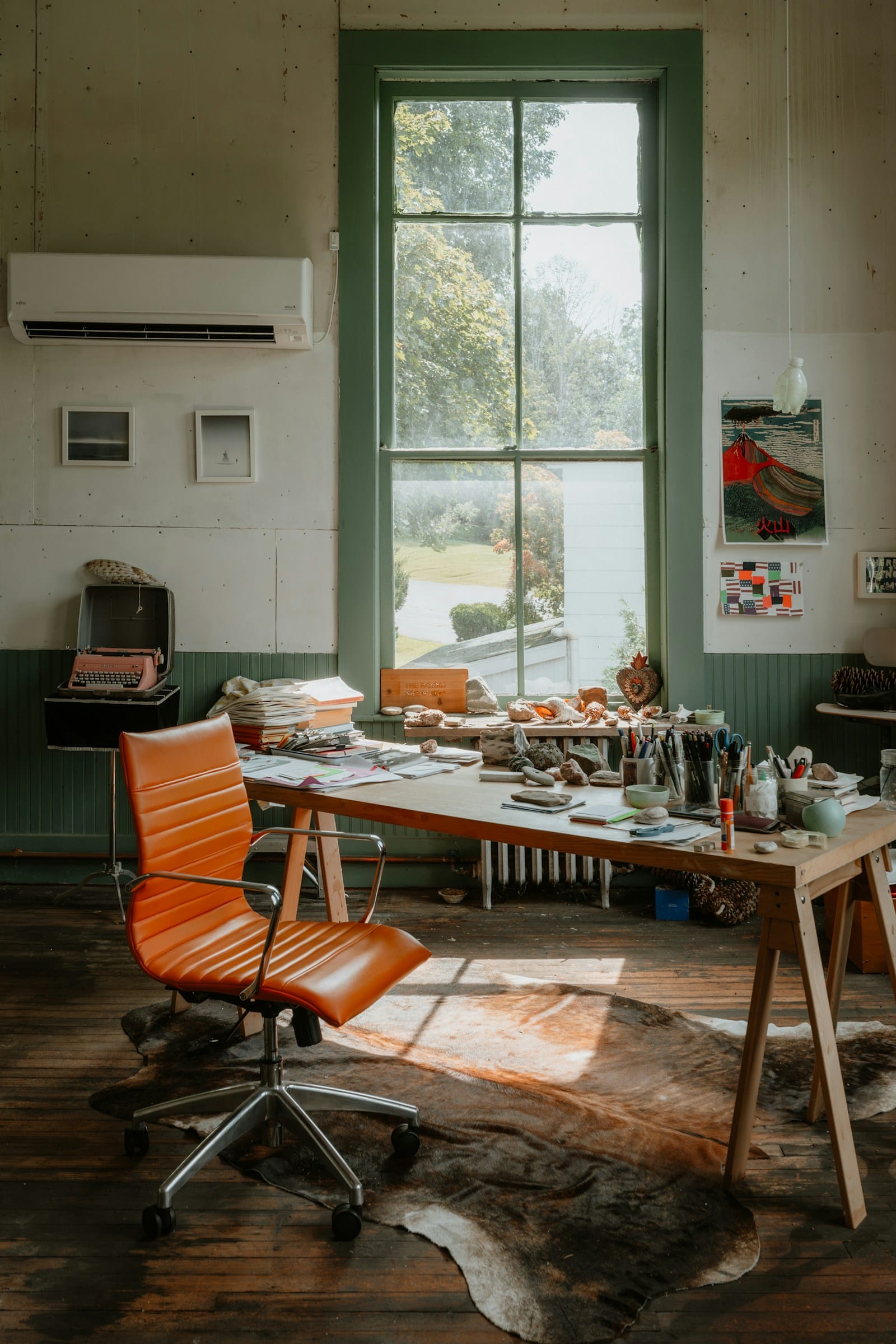 10 Design Trends Creatives Are Exhausted By in 2026 10 Artist creative studio workspace with desk chair and large window representing authentic creative process