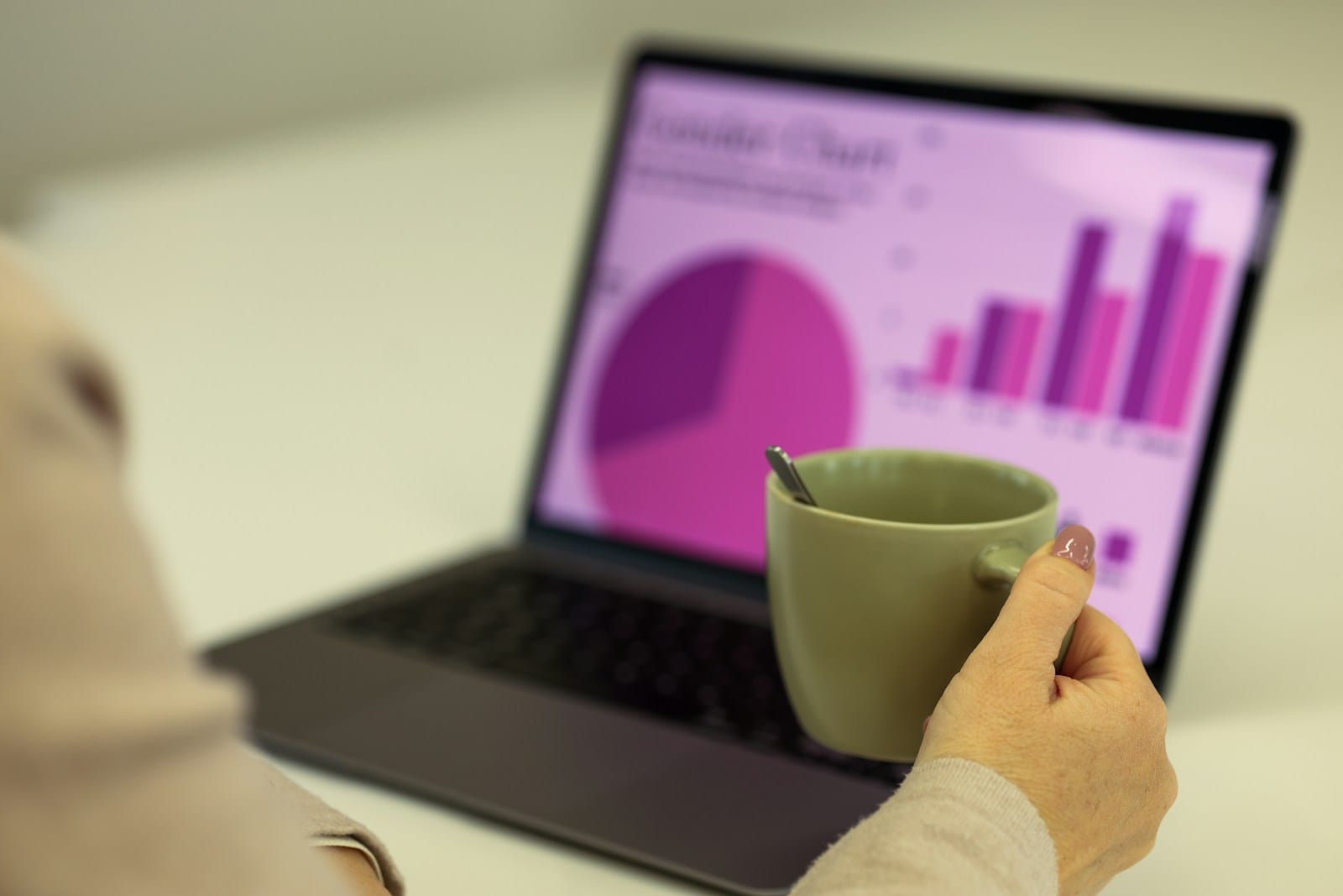 Person working on laptop with coffee for microshifting productivity