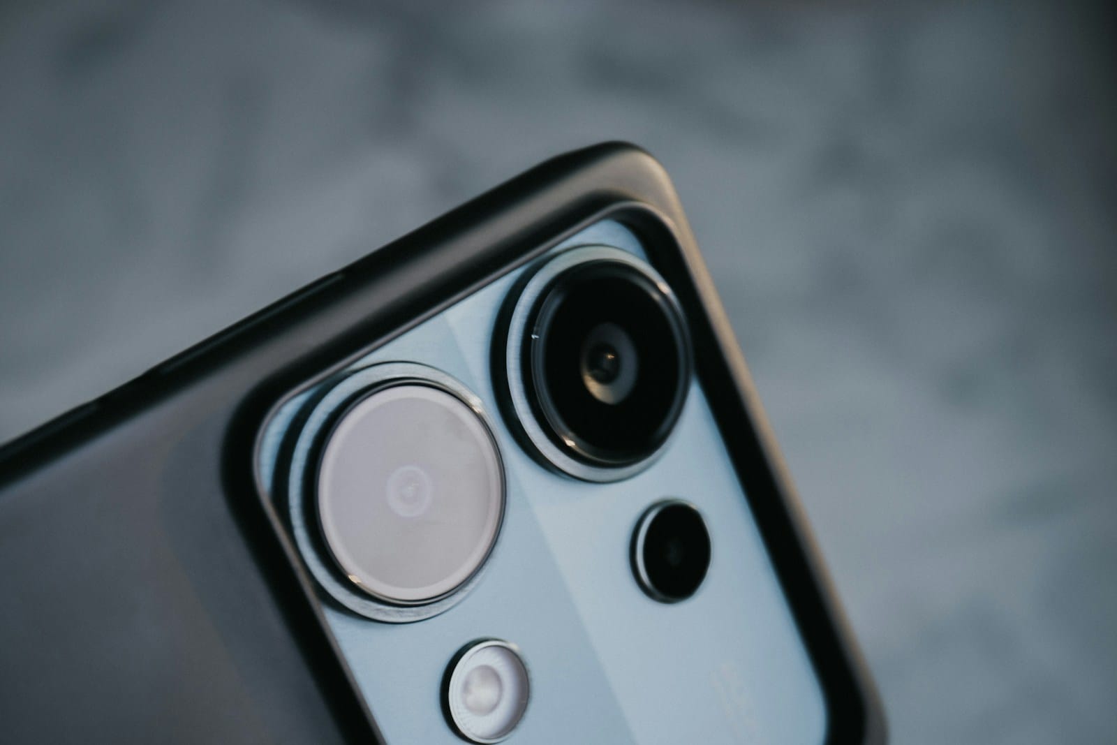 Close-up of a smartphone camera module with multiple lenses showing sensor and lens technology