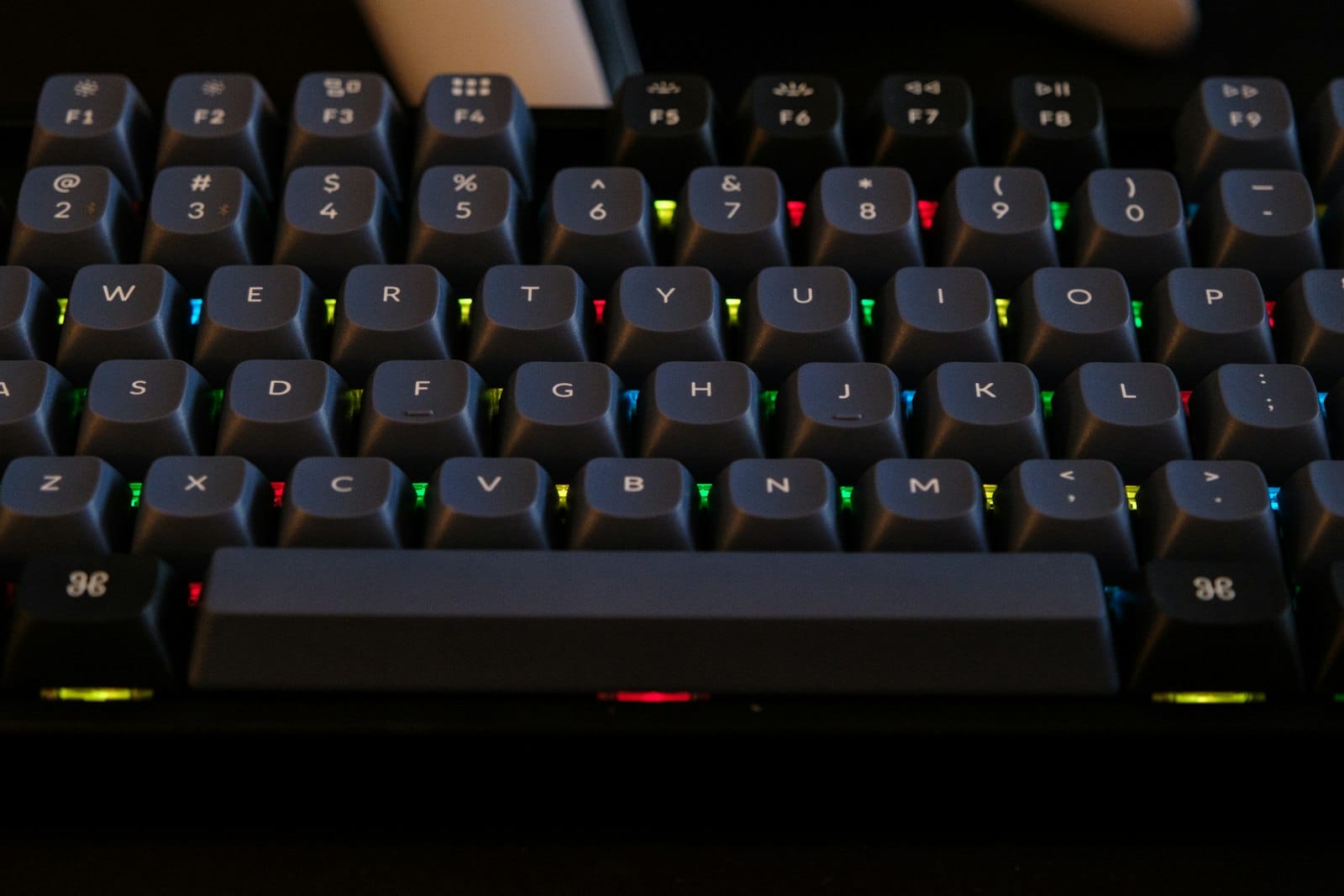 Close up view of a backlit mechanical keyboard with colorful keycaps